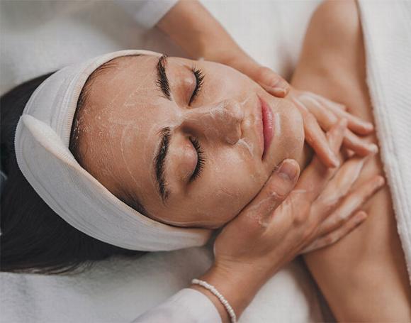 lady laying down for facial treatment